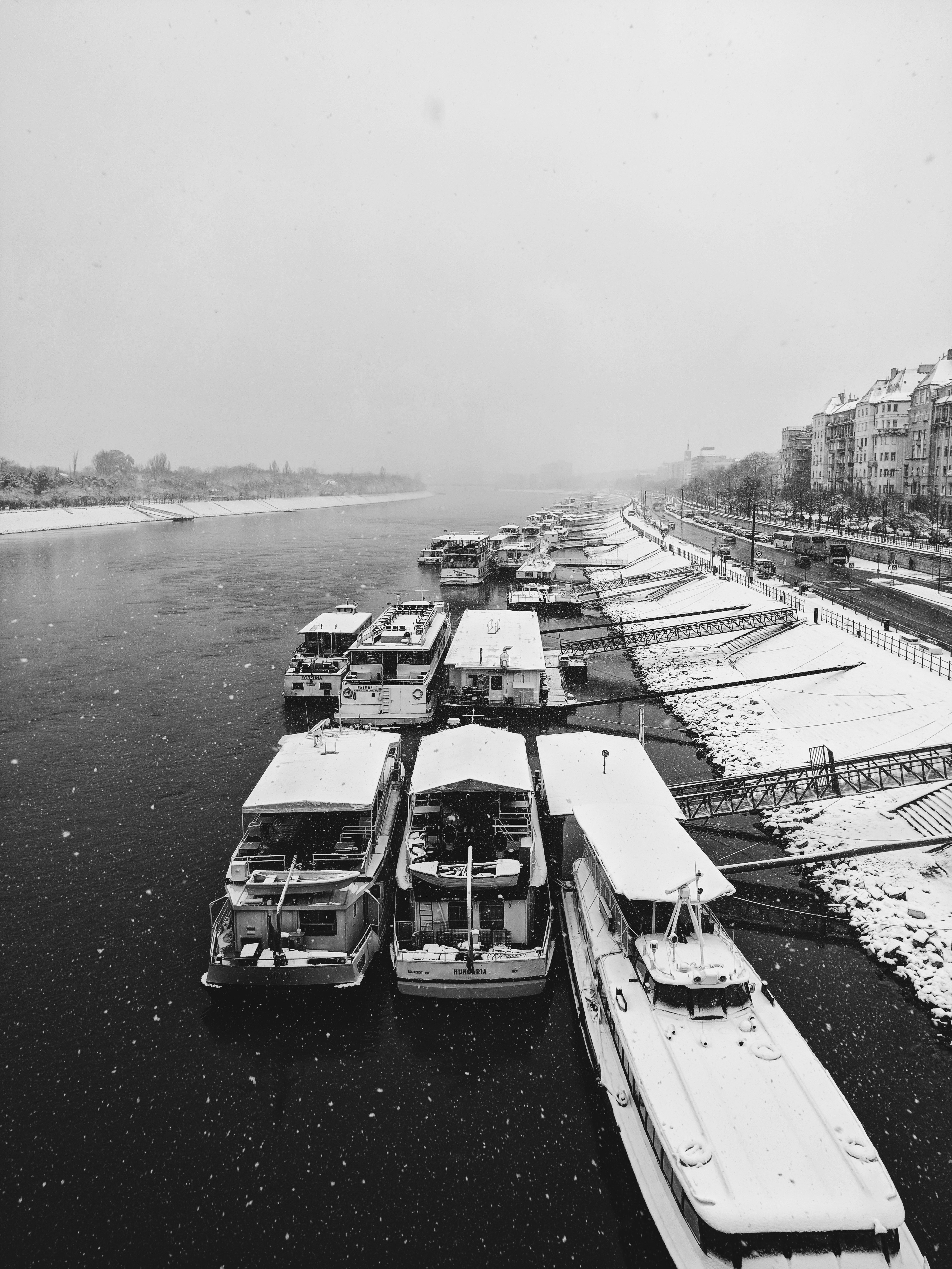 grayscale photography of boats on body of water